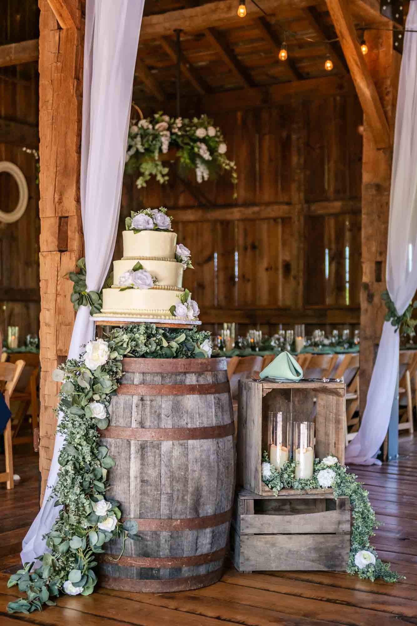 wedding cake and other simple decor displayed at the barn wedding reception venue at pinehall